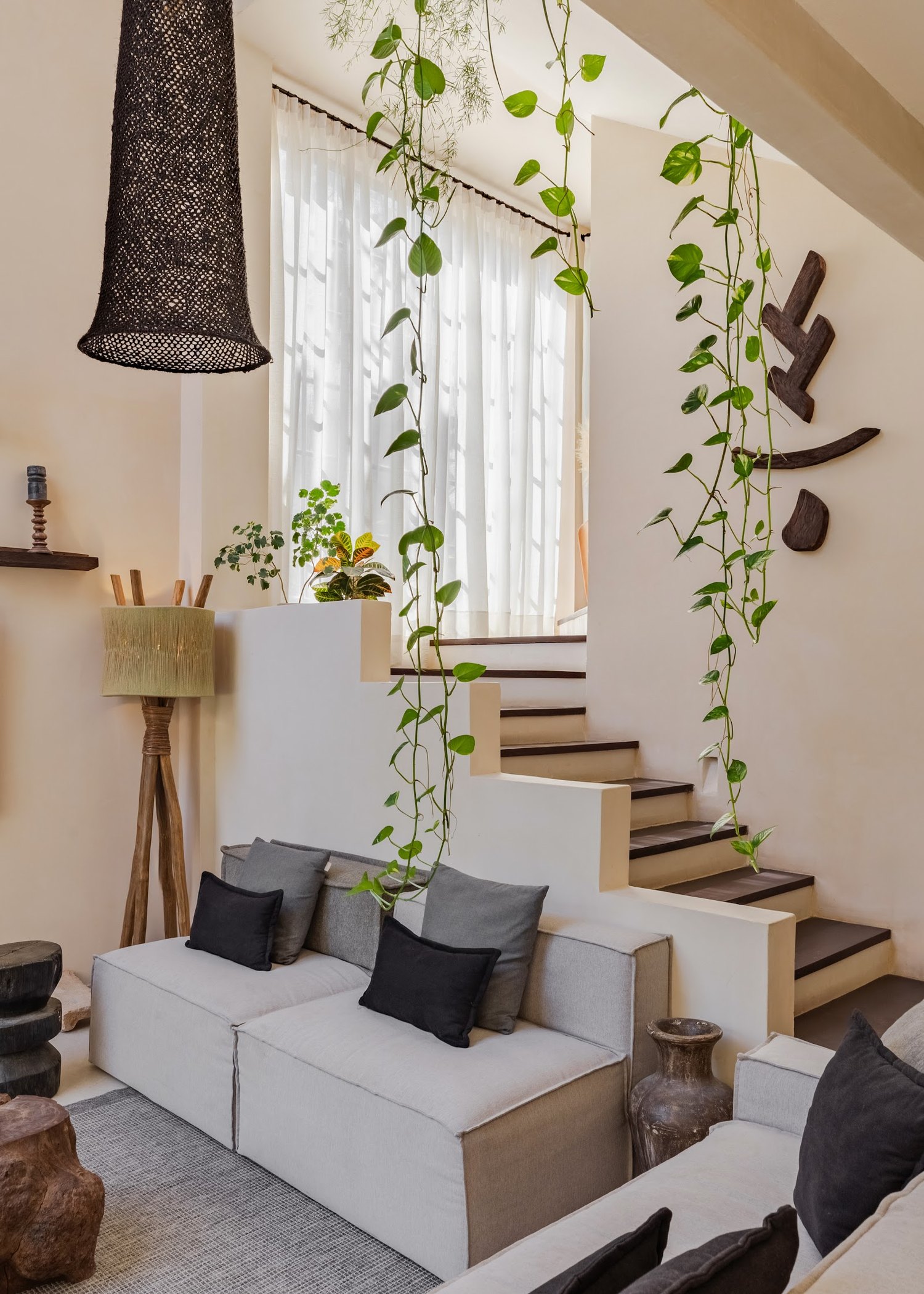 The garden runs straight through the house — greenery framing nearly every view.