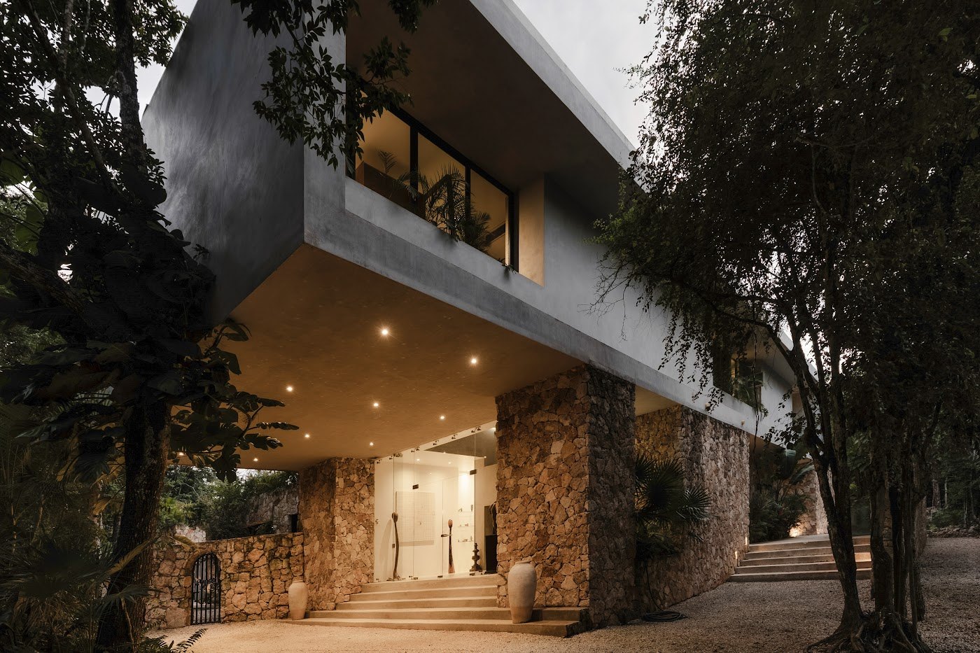 Hand-laid stone and poured concrete &mdash; built to frame the jungle rather than fight it.