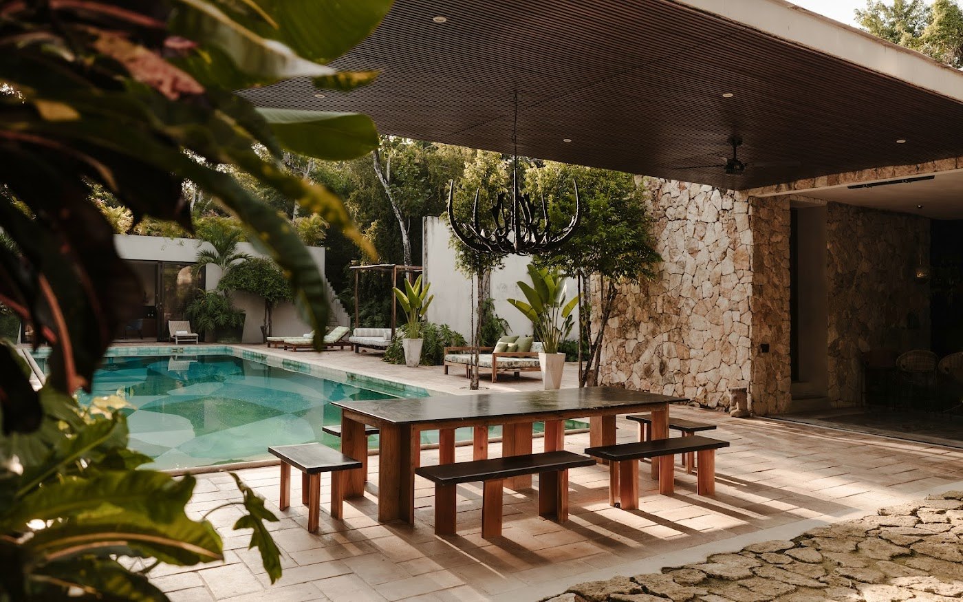 A long table by the pool &mdash; where the best nights at Casa Xolo tend to happen.